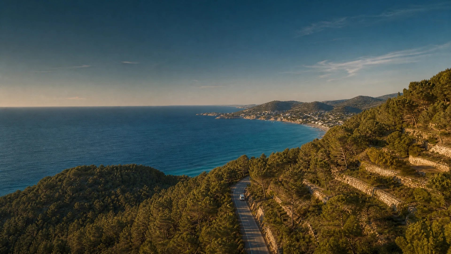 Eastbound Ibiza coastal road with sea view and a quiet shuttle in the distance